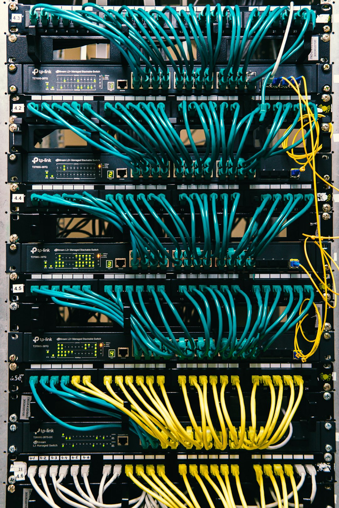 why-choose-us a-rack-of-servers-with-wires-and-wires-attached-to-them-c-lsqecd9oi
