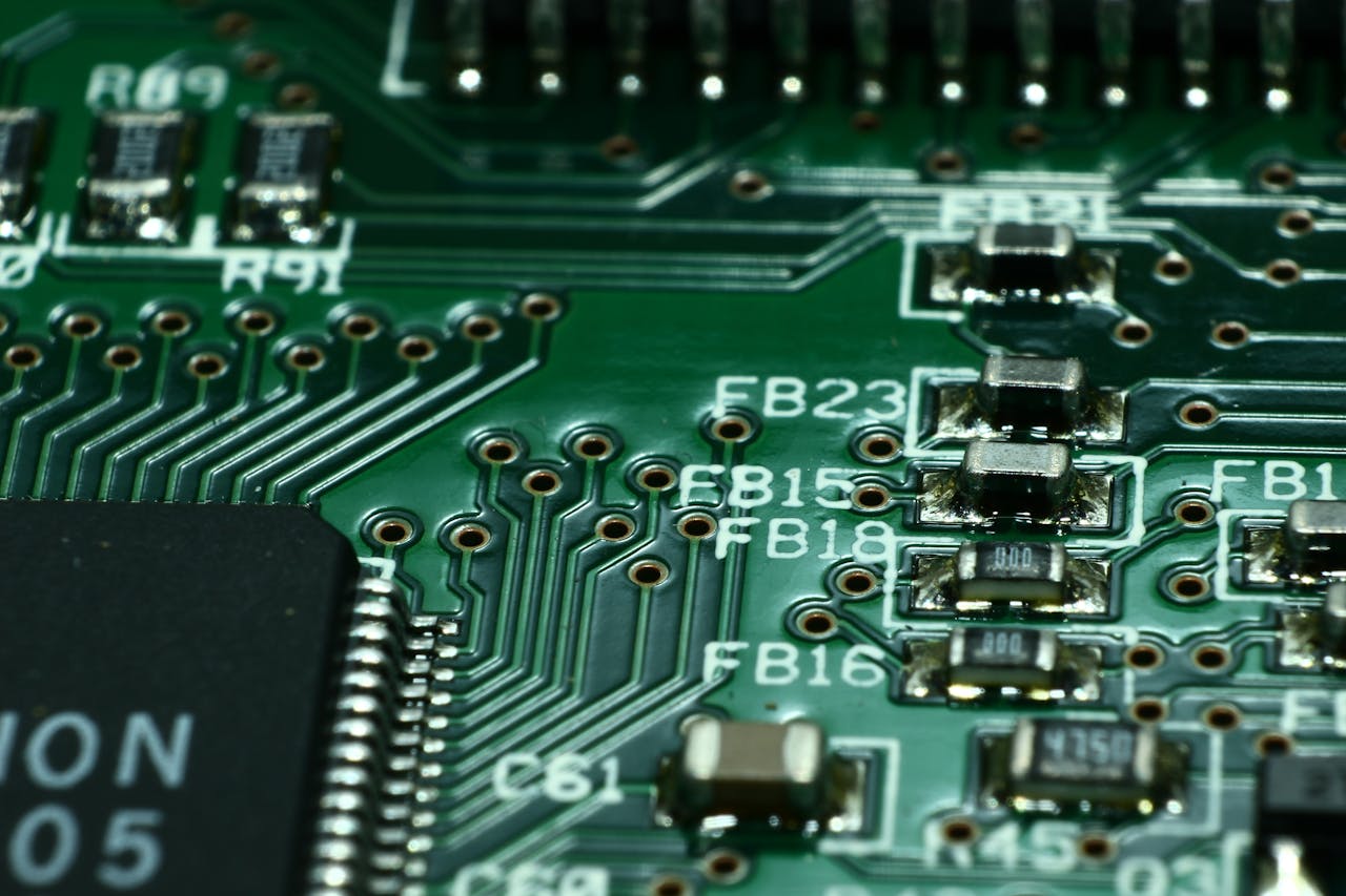 portfolio-04 Detailed macro view of a circuit board showcasing microchips and electronic components.